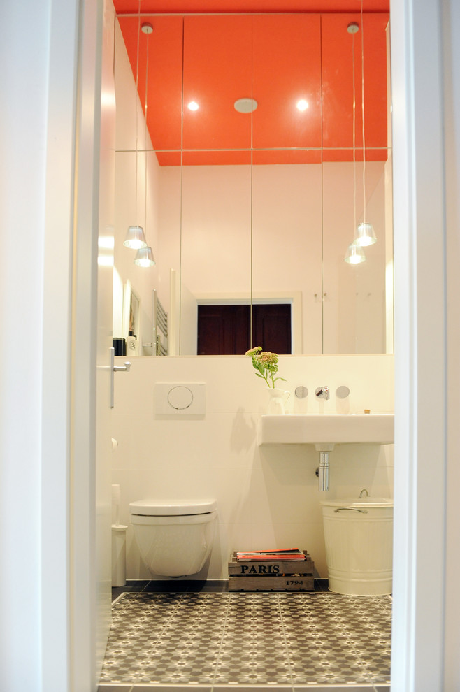 Свежая идея для дизайна: ванная комната среднего размера в современном стиле с плоскими фасадами, душем без бортиков, инсталляцией, белой плиткой, керамической плиткой, белыми стенами, полом из цементной плитки, душевой кабиной, подвесной раковиной и открытым душем - отличное фото интерьера