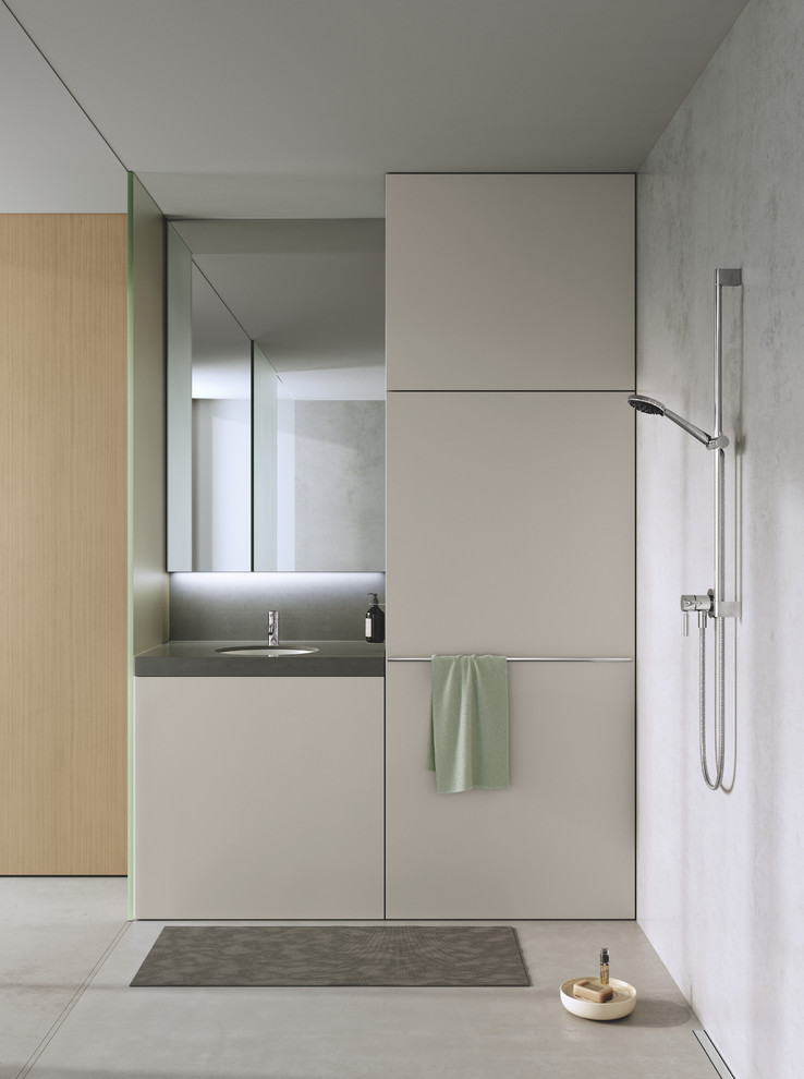 Foto di una stanza da bagno con doccia minimalista di medie dimensioni con ante lisce, ante grigie, pareti grigie, lavabo integrato e top nero