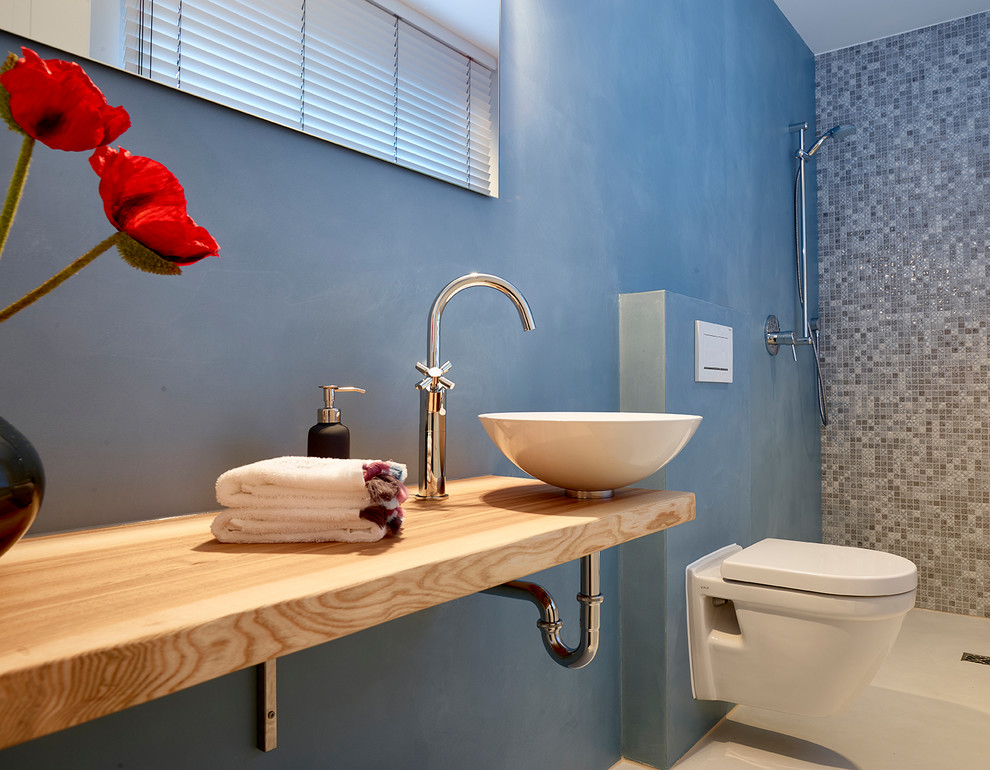Réalisation d'une grande salle d'eau design avec un placard sans porte, une douche à l'italienne, WC séparés, un mur bleu, un sol en carrelage de porcelaine, une vasque, un plan de toilette en bois, un sol beige, aucune cabine et un plan de toilette marron.