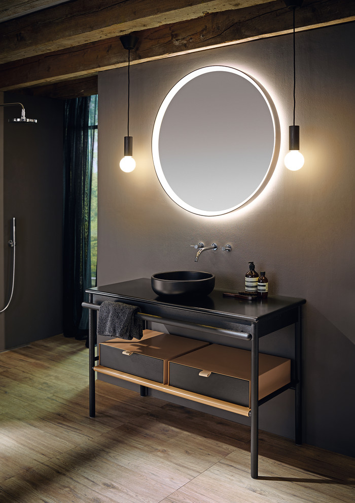 Large modern bathroom in Nuremberg with open cabinets, dark wood cabinets and a vessel sink.