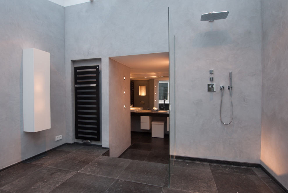 Inspiration for a medium sized contemporary bathroom in Hamburg with black tiles, stone slabs and grey walls.