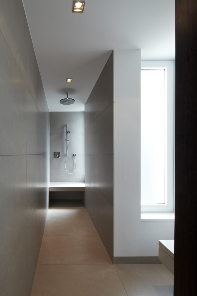 Immagine di un'ampia stanza da bagno padronale design con doccia a filo pavimento, WC sospeso, piastrelle grigie, piastrelle in pietra, pareti bianche, pavimento grigio e doccia aperta