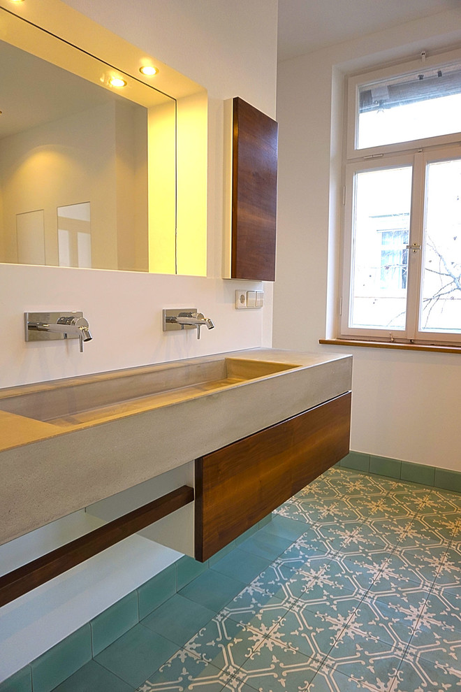 Inspiration for a medium sized contemporary bathroom in Stuttgart with flat-panel cabinets, white walls, porcelain flooring, an integrated sink and concrete worktops.