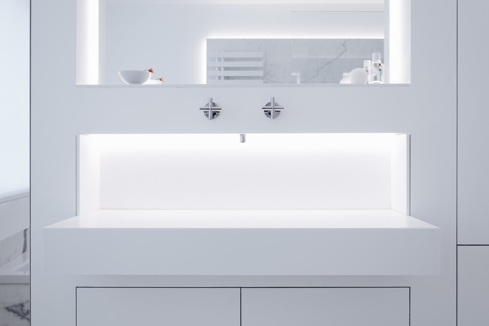 This is an example of a small modern family bathroom in Hamburg with flat-panel cabinets, a built-in bath, a built-in shower, ceramic tiles, white walls, ceramic flooring, a built-in sink, solid surface worktops, white floors, an open shower and white worktops.