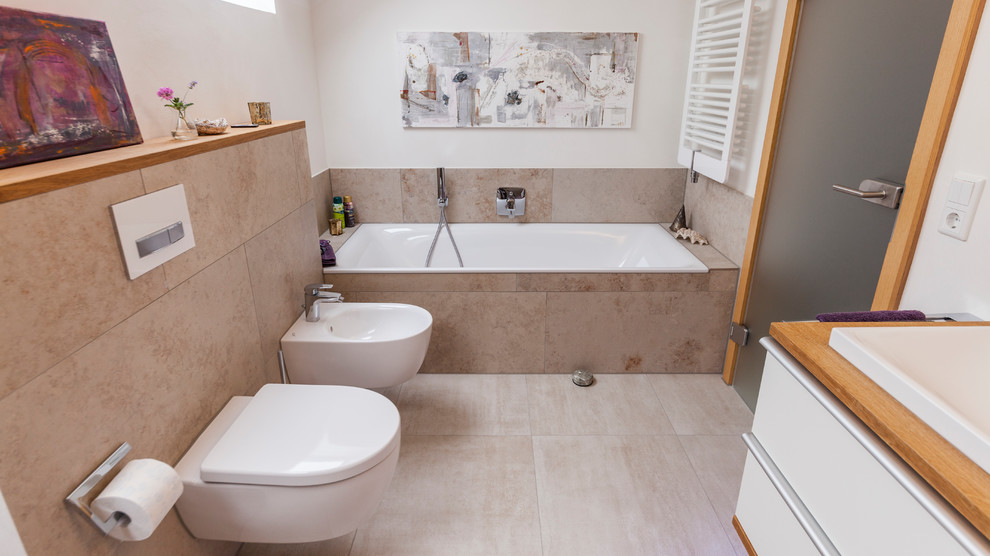 Inspiration for a medium sized contemporary shower room bathroom in Other with flat-panel cabinets, white cabinets, a built-in bath, a bidet, beige tiles, white walls, a built-in sink, wooden worktops, beige floors and brown worktops.