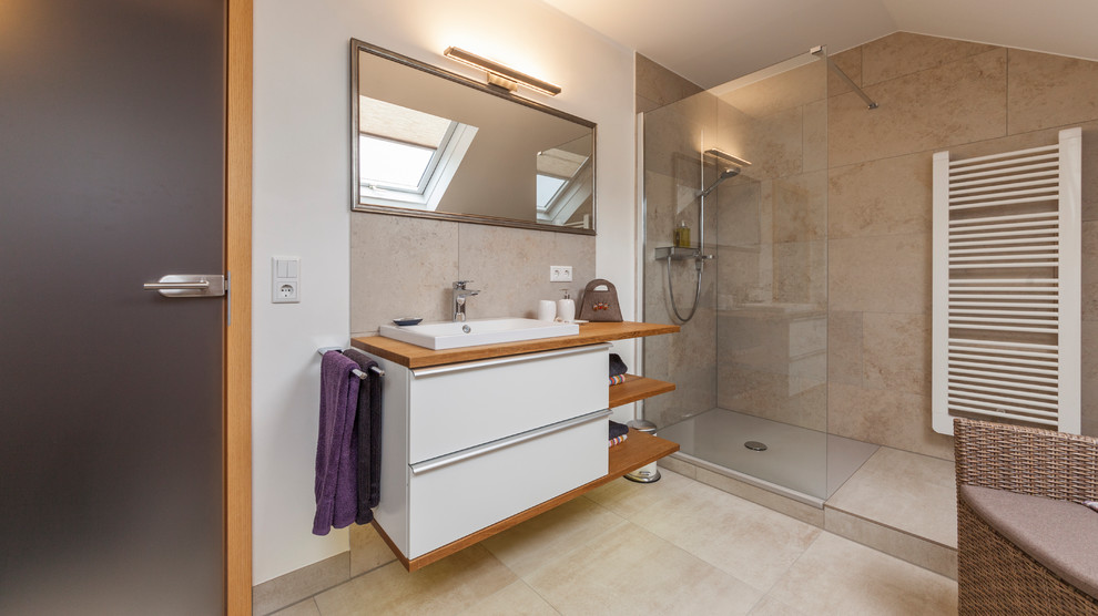 Inspiration for a medium sized contemporary shower room bathroom in Other with flat-panel cabinets, white cabinets, a walk-in shower, beige tiles, white walls, a built-in sink, wooden worktops, beige floors, an open shower and brown worktops.