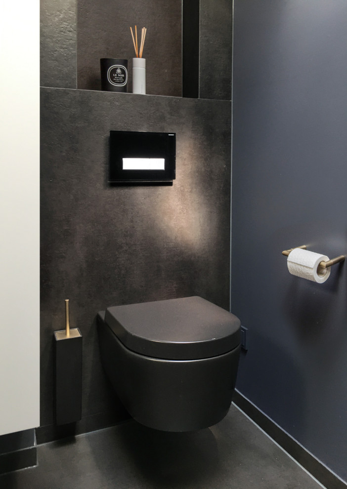 Inspiration for a mid-sized contemporary ceramic tile and black floor powder room remodel in Berlin with a wall-mount toilet, black walls and a built-in vanity