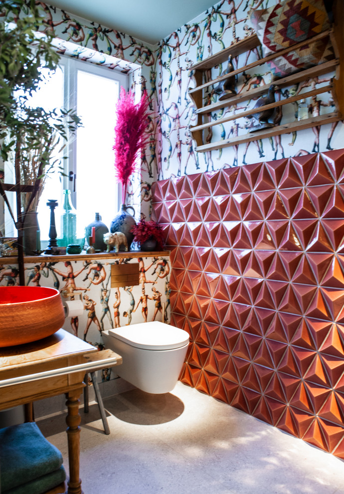 Example of a small eclectic 3/4 pink tile and ceramic tile terrazzo floor, gray floor, single-sink, wallpaper ceiling and wallpaper bathroom design in Hamburg with distressed cabinets, a wall-mount toilet, multicolored walls, a vessel sink, tile countertops, pink countertops and a freestanding vanity