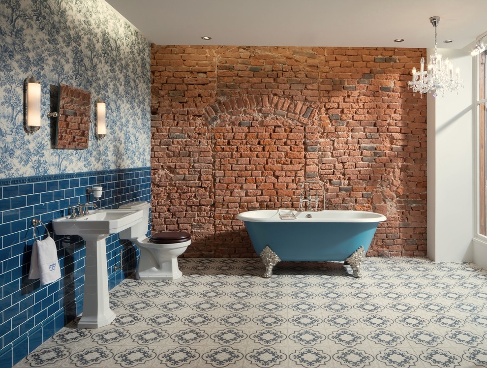 Inspiration för stora industriella badrum med dusch, med ett fristående badkar, en toalettstol med hel cisternkåpa, blå kakel, klinkergolv i keramik, ett konsol handfat, en dusch/badkar-kombination, tunnelbanekakel, flerfärgade väggar och vitt golv