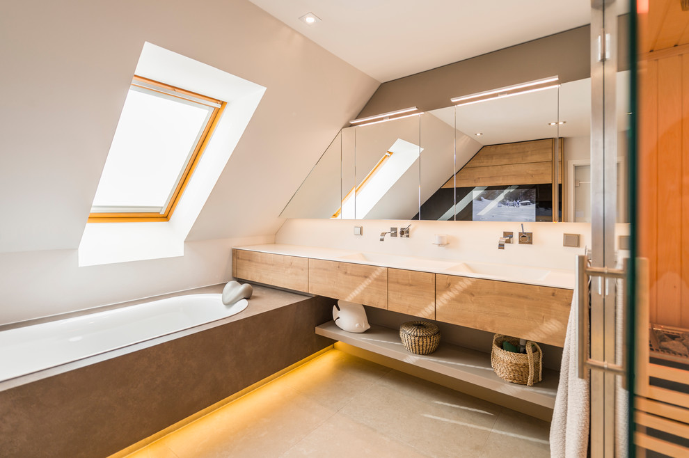 This is an example of a medium sized contemporary bathroom in Dresden with a built-in bath, a built-in shower, a wall mounted toilet, an integrated sink, brown floors and a sliding door.