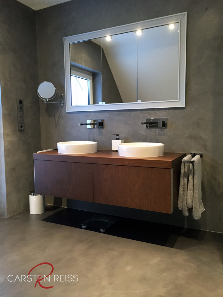 Bathroom - small industrial master concrete floor bathroom idea in Nuremberg with gray walls