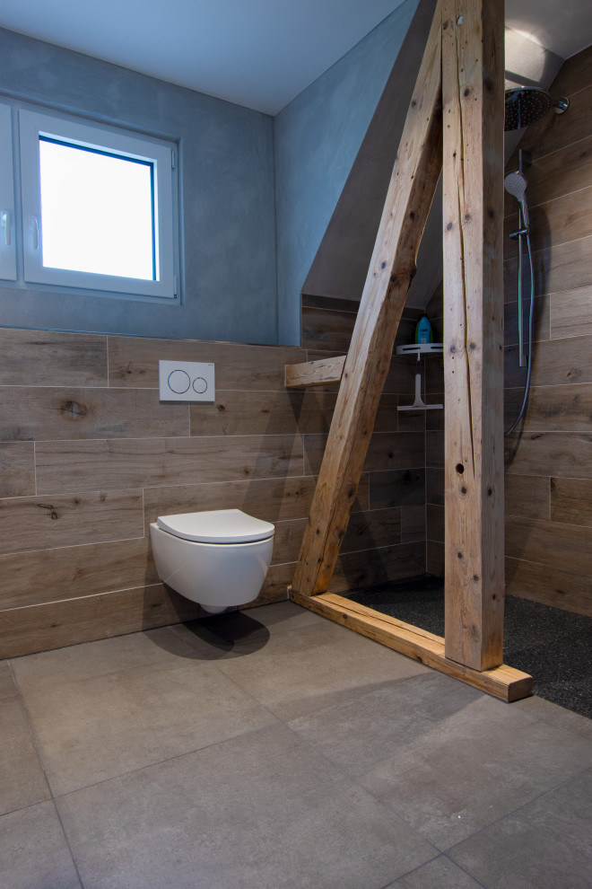 Example of a mid-sized minimalist 3/4 brown tile and wood-look tile ceramic tile and gray floor bathroom design in Other with a wall-mount toilet and brown walls