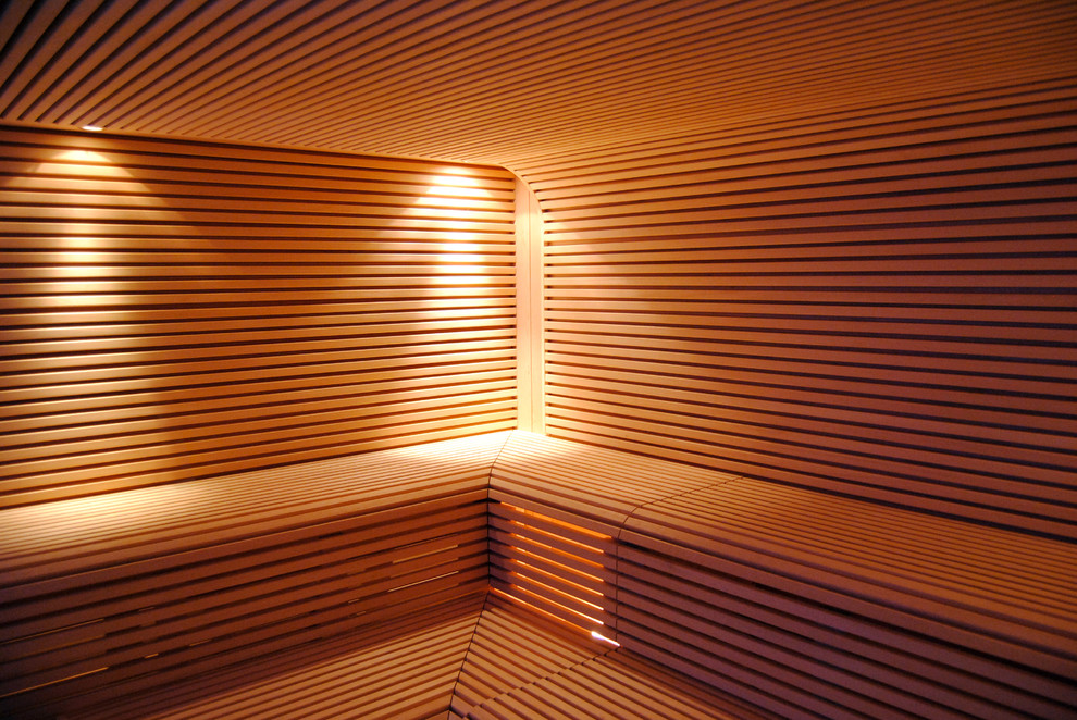 Design ideas for a large modern sauna bathroom in Berlin with open cabinets, beige cabinets, a corner bath, a built-in shower, a two-piece toilet, beige tiles, brown tiles, beige walls, light hardwood flooring, a vessel sink, wooden worktops, beige floors and an open shower.