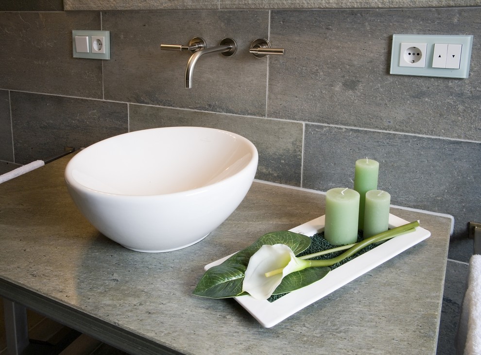 Trendy stone tile walk-in shower photo in Other with gray walls and a vessel sink
