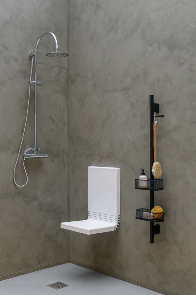 Idéer för funkis badrum, med en kantlös dusch och grå väggar