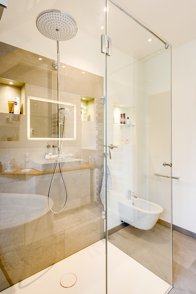 Bathroom - large contemporary 3/4 white tile and ceramic tile ceramic tile and beige floor bathroom idea in Hamburg with flat-panel cabinets, white cabinets, a wall-mount toilet, white walls, a vessel sink, solid surface countertops and brown countertops