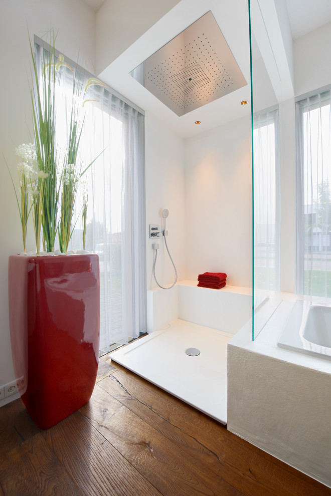 Modern inredning av ett mellanstort en-suite badrum, med ett badkar i en alkov, en öppen dusch, vita väggar, mellanmörkt trägolv och med dusch som är öppen