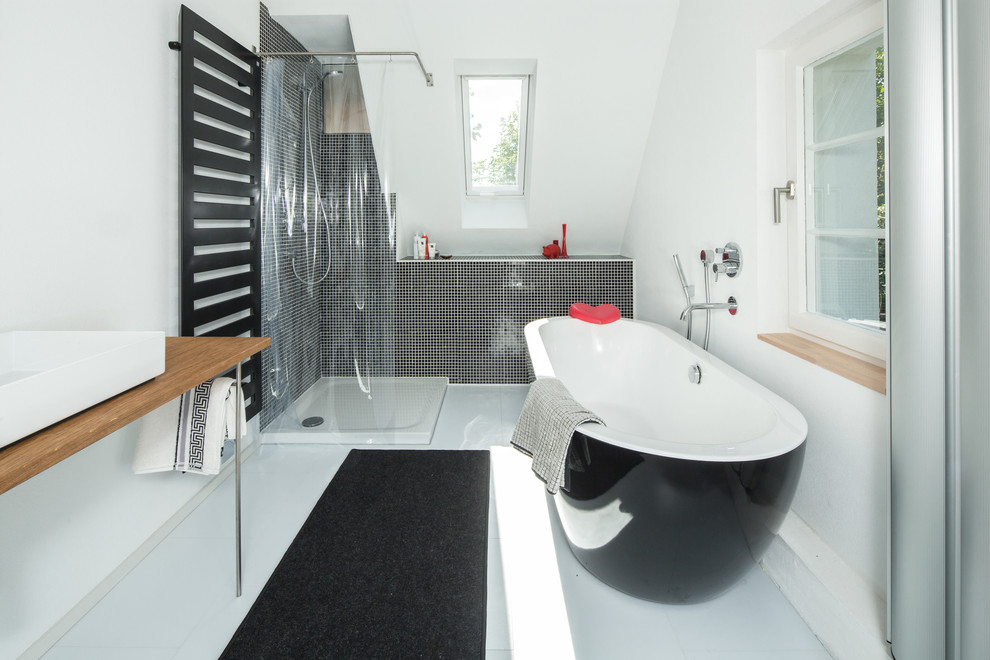 Example of a mid-sized trendy 3/4 black tile and mosaic tile white floor bathroom design in Stuttgart with white walls, a vessel sink, wood countertops and brown countertops