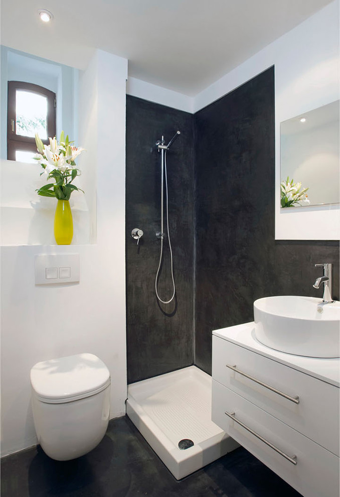 Small trendy 3/4 corner shower photo in Cologne with a vessel sink, flat-panel cabinets, white cabinets, a wall-mount toilet and white walls