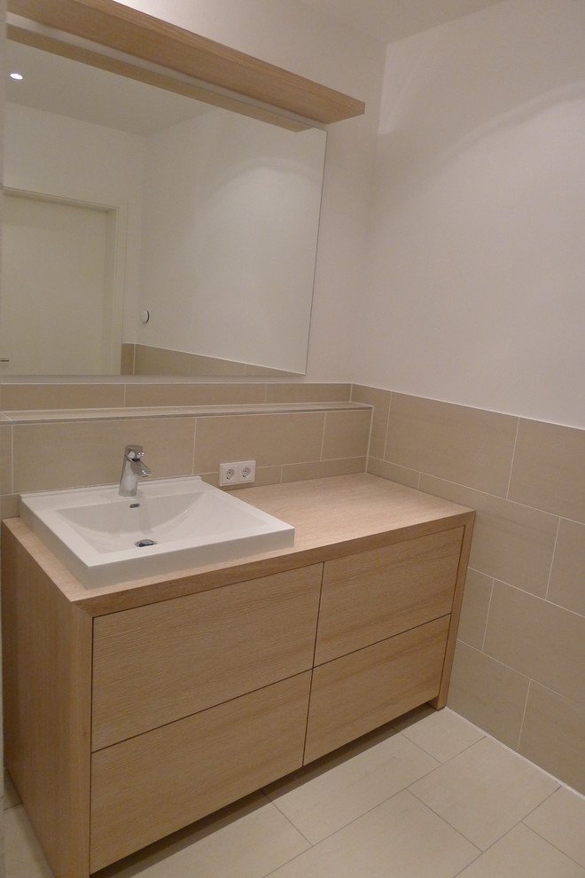 Example of a small trendy 3/4 beige tile beige floor bathroom design in Munich with flat-panel cabinets, brown cabinets, white walls, a vessel sink and wood countertops