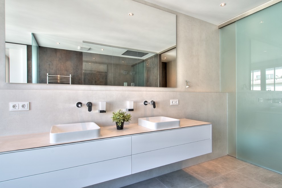 Large contemporary bathroom in Berlin with flat-panel cabinets, white cabinets, a walk-in shower, grey walls, a vessel sink and an open shower.