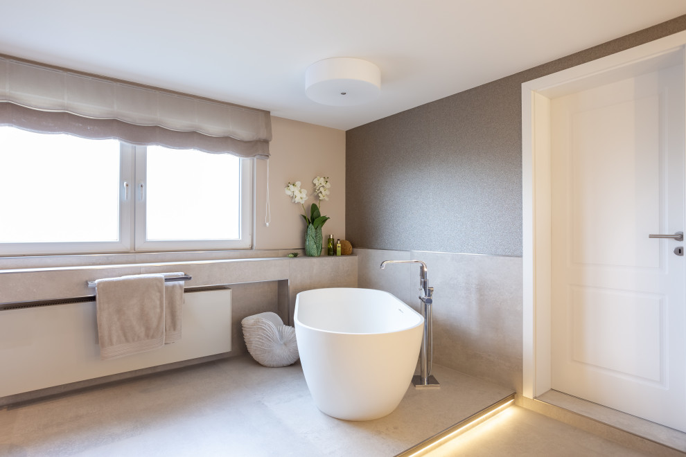 Inspiration for an expansive contemporary shower room bathroom in Essen with flat-panel cabinets, brown cabinets, a freestanding bath, a built-in shower, a wall mounted toilet, brown tiles, metal tiles, beige walls, ceramic flooring, a vessel sink, wooden worktops, grey floors, an open shower and brown worktops.