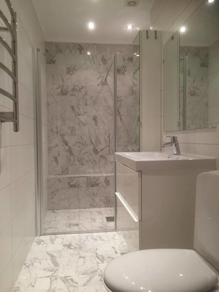 Photo of a medium sized modern shower room bathroom in Stockholm with grey tiles.