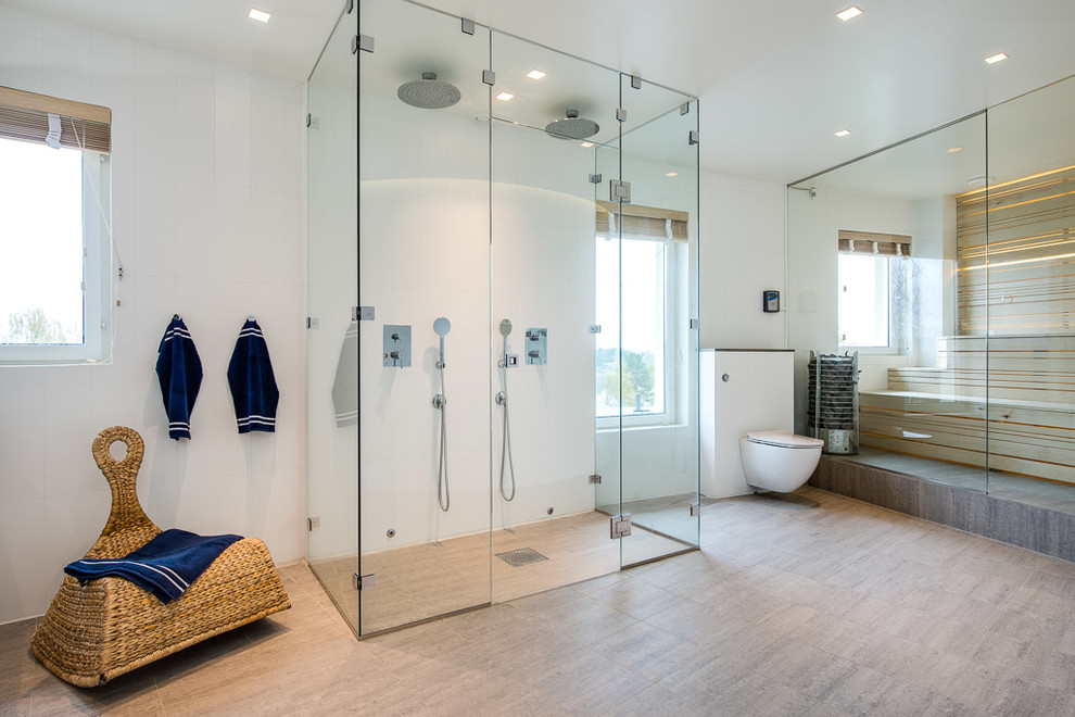 Large contemporary ensuite bathroom in Stockholm with a built-in shower, a two-piece toilet, white walls and ceramic flooring.