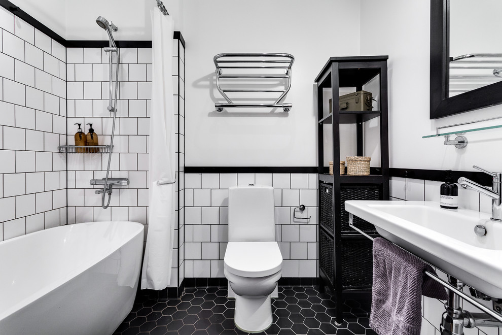 Mid-sized danish 3/4 black tile porcelain tile bathroom photo in Stockholm with white walls, a trough sink, open cabinets, black cabinets and a one-piece toilet