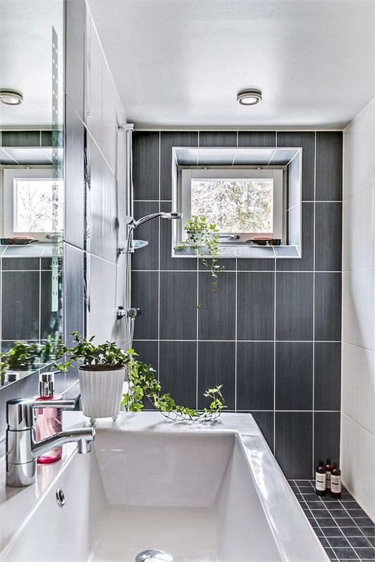 Inspiration for a small classic shower room bathroom in Stockholm with flat-panel cabinets, brown cabinets, a built-in shower, a one-piece toilet, brown tiles and brown walls.