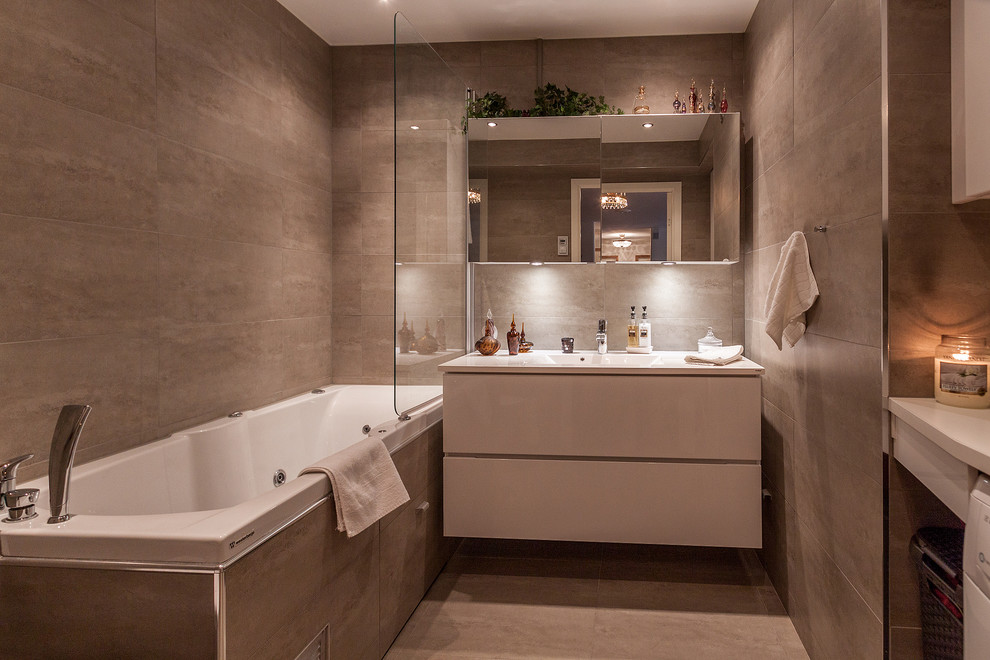 Example of a large trendy brown tile and ceramic tile ceramic tile bathroom design in Stockholm with flat-panel cabinets, white cabinets, brown walls and a console sink