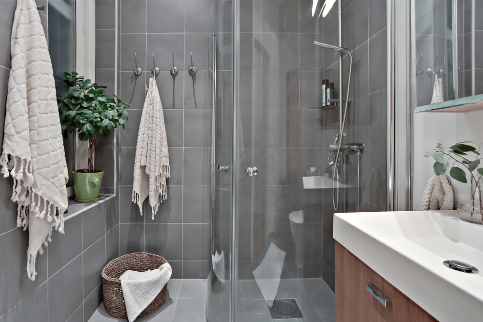 Idéer för skandinaviska badrum, med en hörndusch, grå kakel och grå väggar