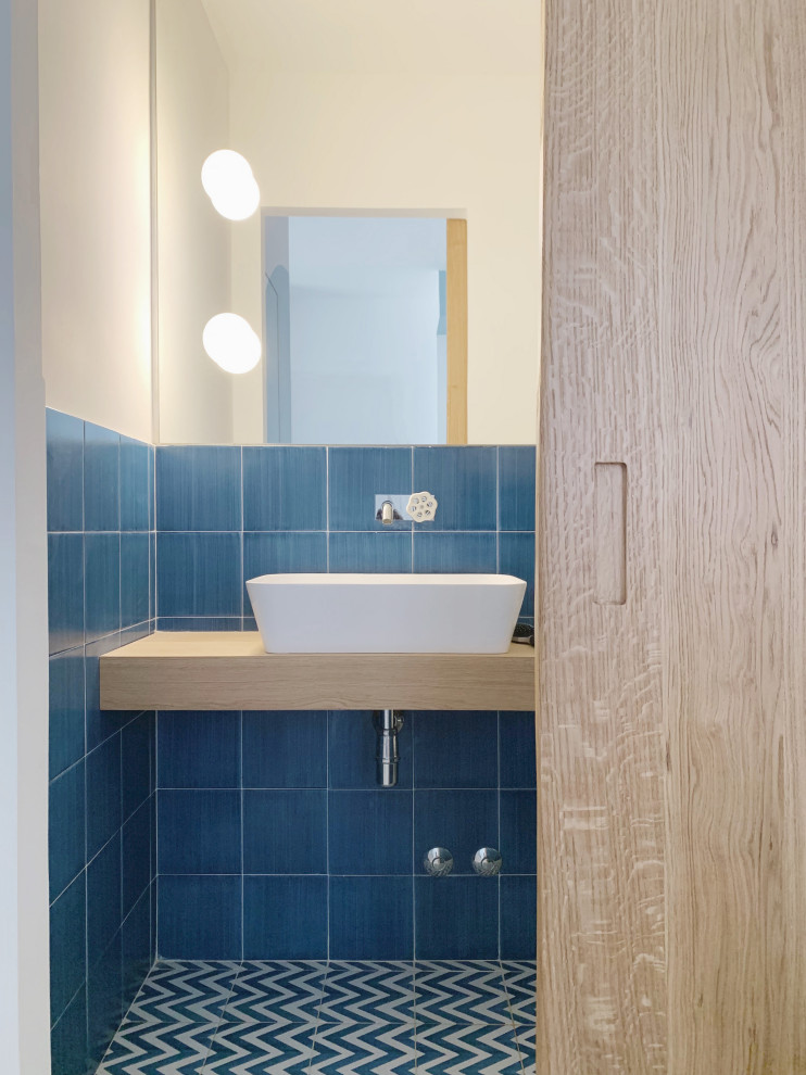 На фото: маленький туалет в средиземноморском стиле с светлыми деревянными фасадами, синей плиткой и керамической плиткой для на участке и в саду с