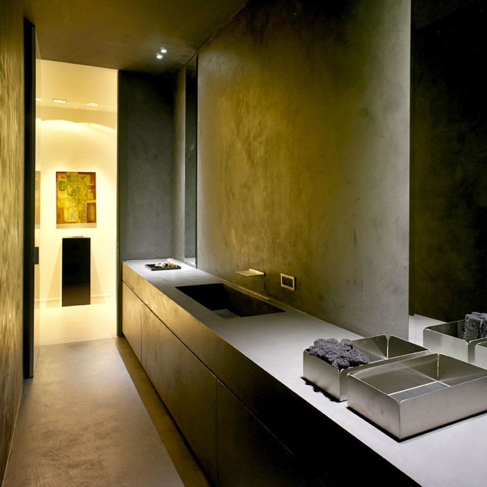 Ejemplo de aseo moderno pequeño con armarios con paneles lisos, paredes grises, lavabo encastrado, encimera de acrílico y suelo gris