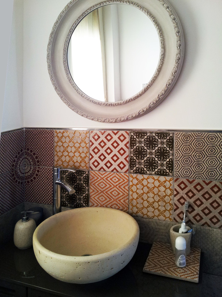 This is an example of a small contemporary cloakroom in Catania-Palermo with flat-panel cabinets, brown cabinets, a two-piece toilet, multi-coloured tiles, porcelain tiles, white walls, porcelain flooring, a vessel sink and laminate worktops.