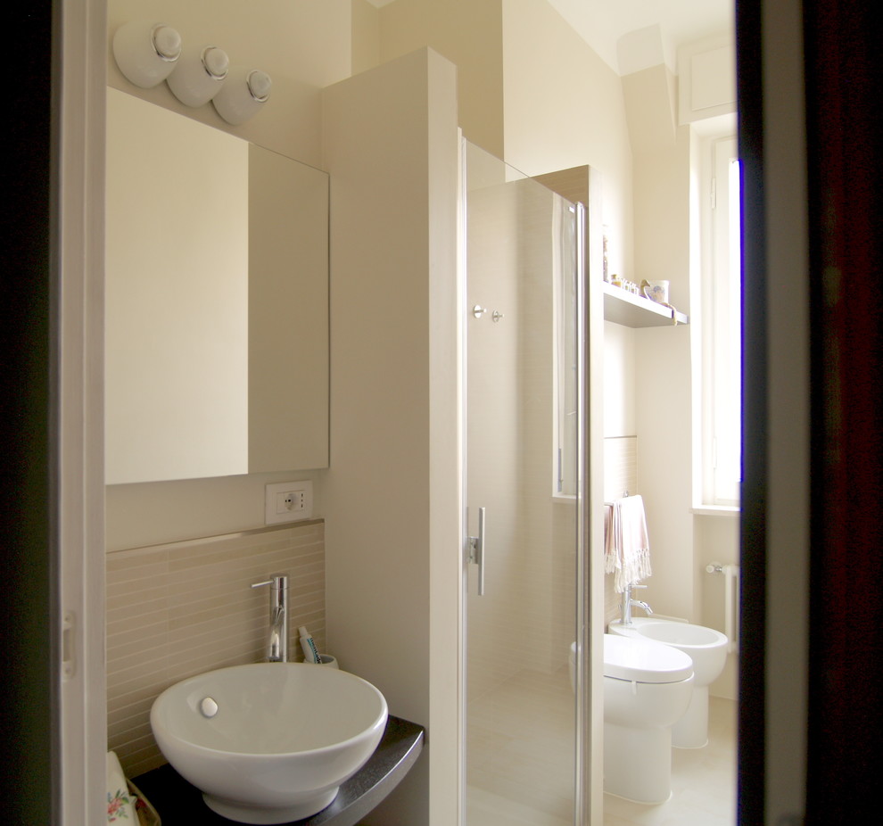 Bild på ett litet funkis toalett, med en toalettstol med separat cisternkåpa, beige kakel, porslinskakel, beige väggar, klinkergolv i porslin, ett fristående handfat och beiget golv