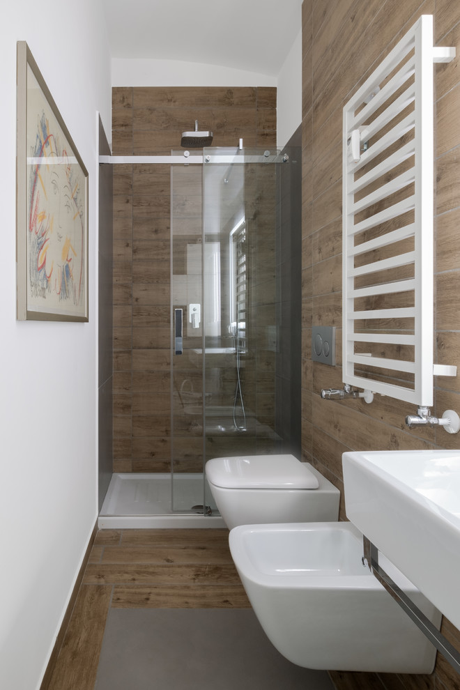 Idées déco pour un petit WC suspendu en bois clair avec un placard à porte plane, un carrelage marron, des carreaux en allumettes, un mur blanc, un sol en carrelage de porcelaine, un lavabo suspendu et un sol marron.