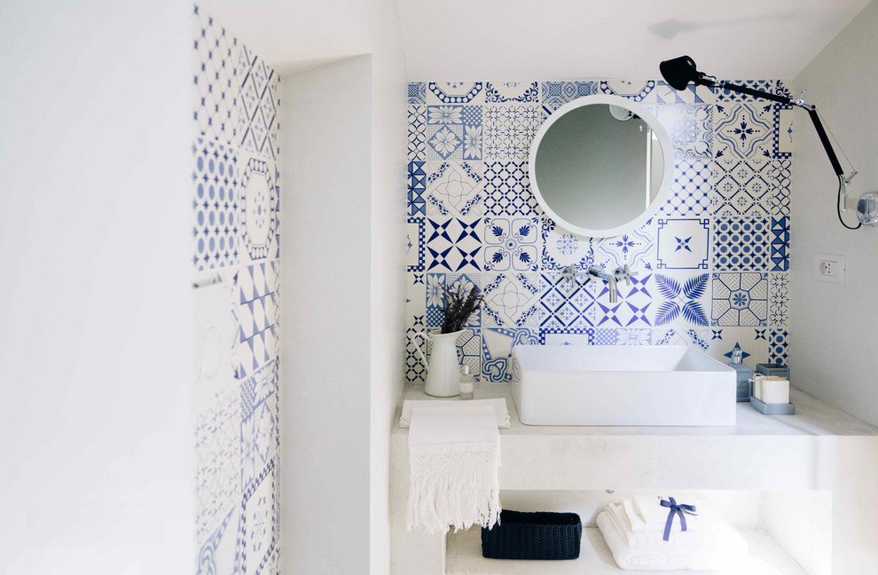 Design ideas for a mediterranean cloakroom in Other with multi-coloured tiles, ceramic tiles, multi-coloured walls, medium hardwood flooring, a trough sink and open cabinets.