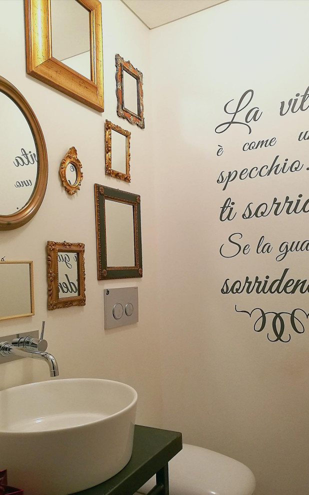 Powder room - small shabby-chic style dark wood floor and multicolored floor powder room idea in Other with open cabinets, black cabinets, a one-piece toilet, white walls, a vessel sink, solid surface countertops and black countertops