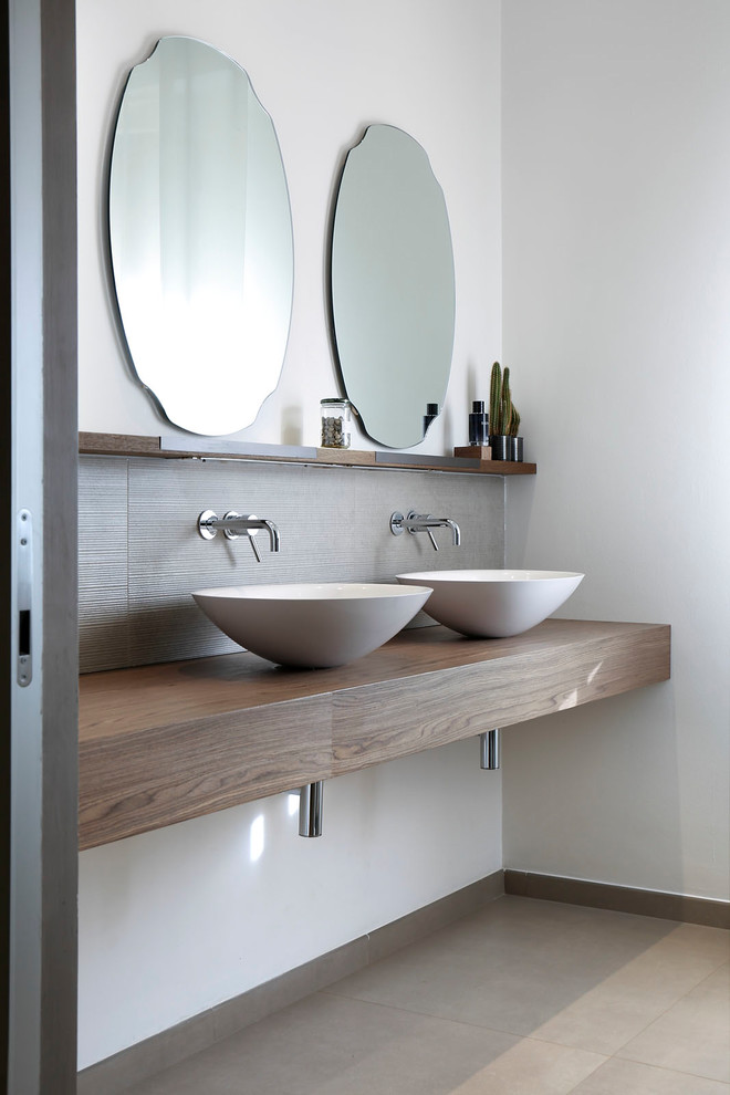 Inspiration for a contemporary cloakroom in Florence with open cabinets, dark wood cabinets, white walls and wooden worktops.