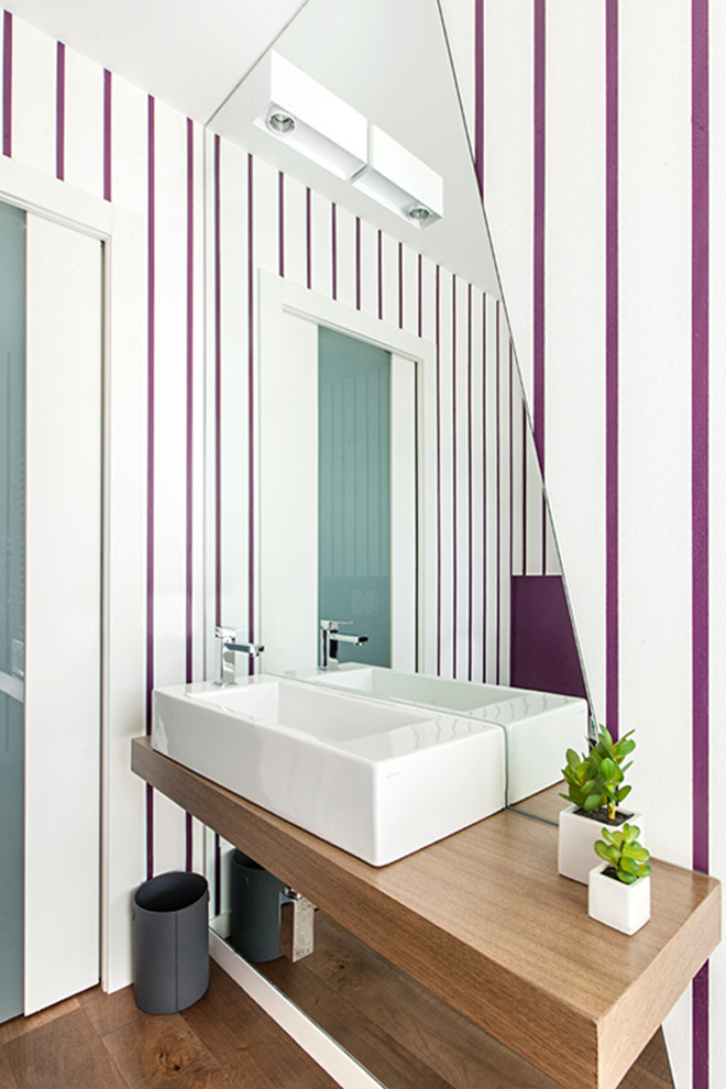 Foto di un bagno di servizio design con ante in legno scuro, pareti multicolore, pavimento in legno massello medio, lavabo sospeso, top in legno, pavimento marrone e top marrone