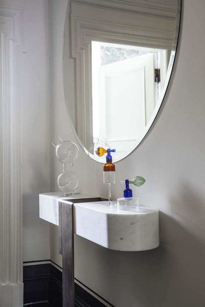 Photo of a victorian cloakroom in London with marble worktops, white worktops and white walls.