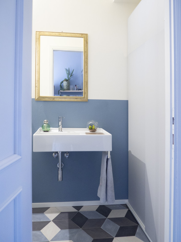 Inspiration for a small contemporary cloakroom in Other with blue walls, porcelain flooring, a wall-mounted sink and multi-coloured floors.