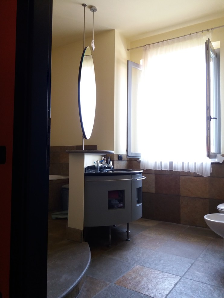 Exempel på ett stort modernt svart svart toalett, med släta luckor, grå skåp, en vägghängd toalettstol, gul kakel, kakelplattor, gula väggar, kalkstensgolv, ett nedsänkt handfat, marmorbänkskiva och flerfärgat golv