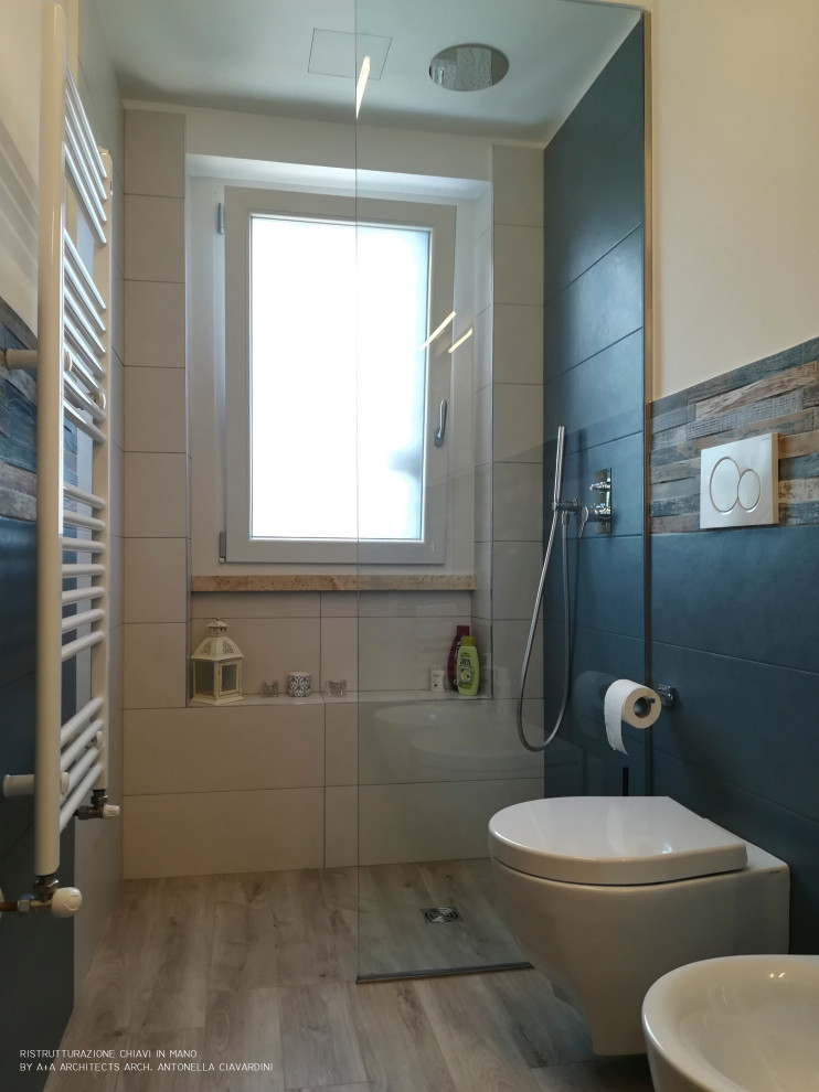 This is an example of a small contemporary bathroom in Other with flat-panel cabinets, light wood cabinets, a wall mounted toilet, multi-coloured tiles, porcelain tiles, white walls, porcelain flooring, a wall-mounted sink, solid surface worktops, brown floors and white worktops.