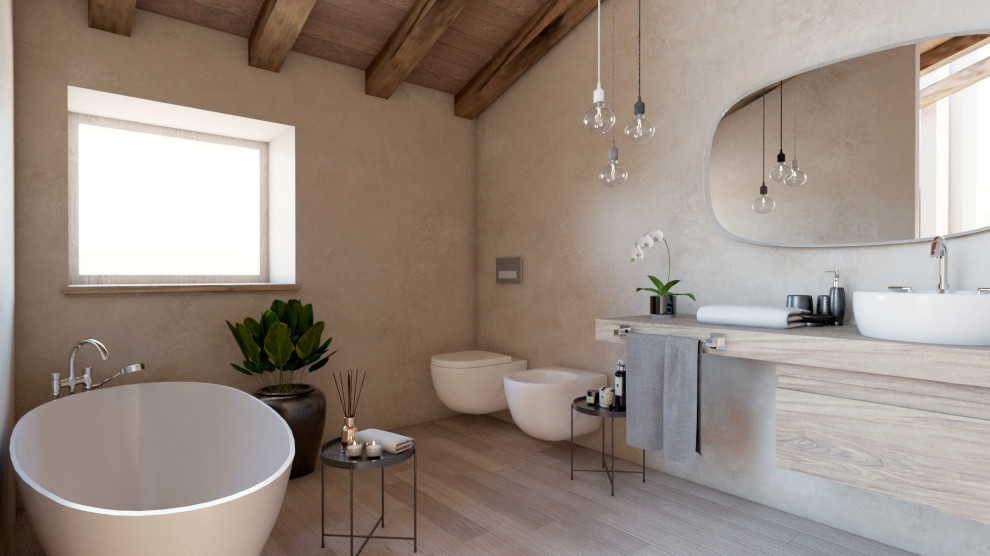 Modern inredning av ett litet badrum, med släta luckor, skåp i ljust trä, en vägghängd toalettstol, ljust trägolv, ett fristående handfat och träbänkskiva