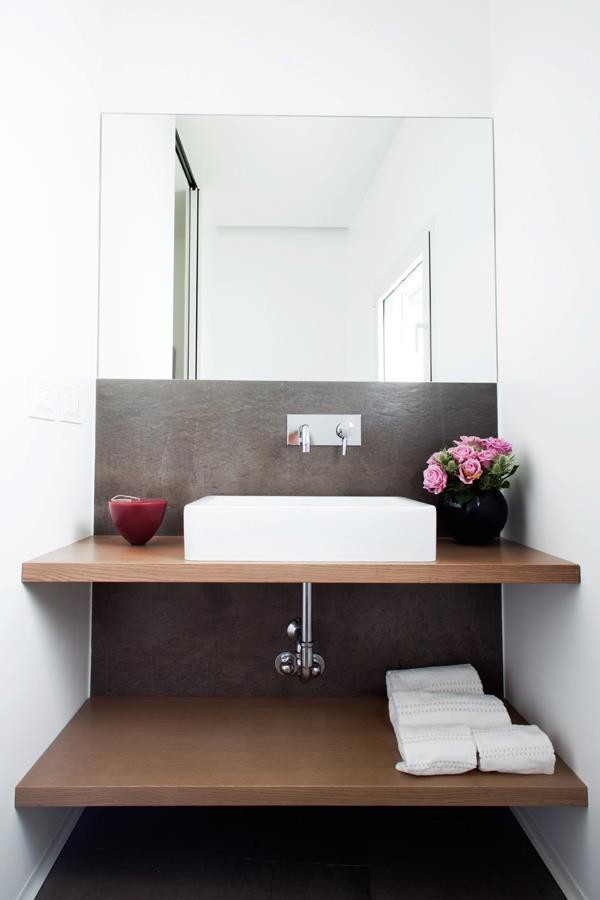 Photo of a small contemporary cloakroom in Milan with open cabinets, light wood cabinets, grey tiles, white walls, porcelain flooring, a vessel sink, wooden worktops, a bidet, stone slabs and brown worktops.