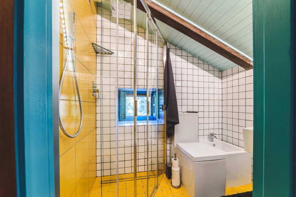 Foto på ett litet funkis badrum, med öppna hyllor, turkosa skåp, en toalettstol med hel cisternkåpa, flerfärgad kakel, porslinskakel, flerfärgade väggar, mosaikgolv, ett väggmonterat handfat och gult golv