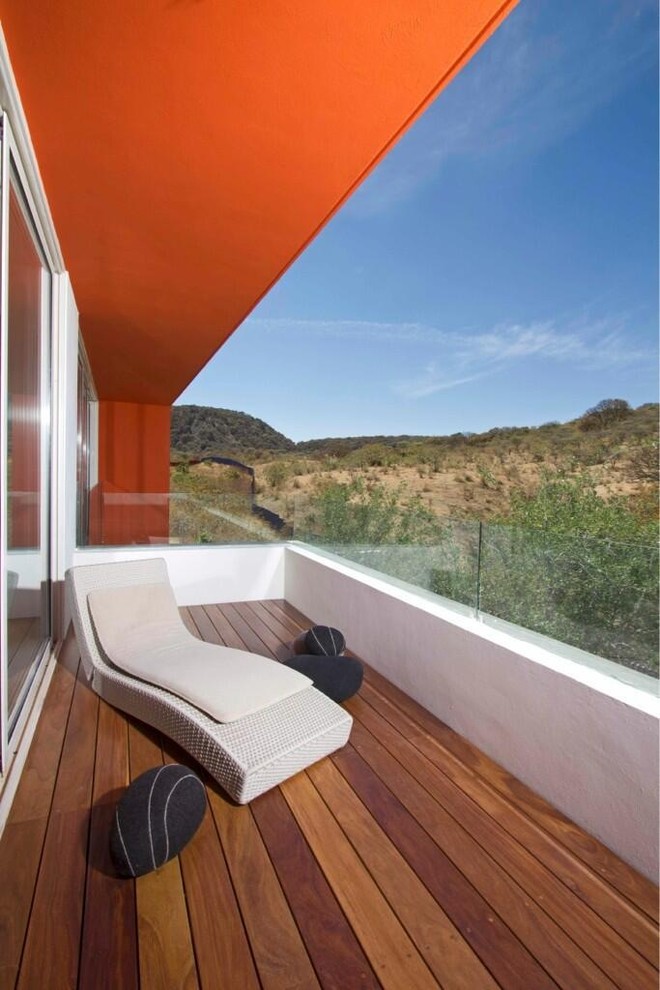 Inspiration for a contemporary balcony in Other with a roof extension.