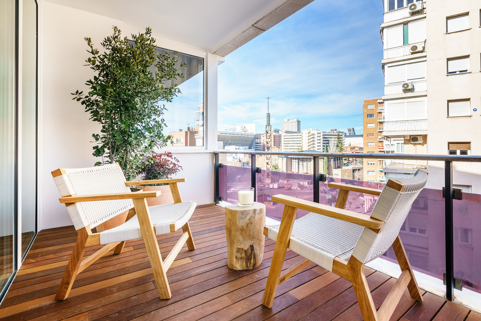 Balcony - small coastal metal railing balcony idea in Madrid with a roof extension